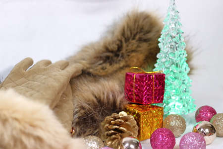Christmas glittering decoration with fur stall and gloves (white background)の写真素材