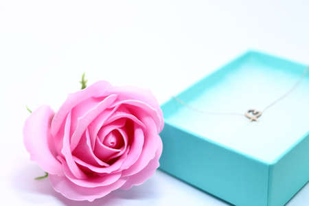 Heart necklace and pink rose in gift boxの写真素材