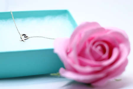 Heart necklace and pink rose in gift boxの写真素材