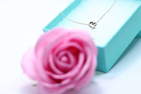Heart necklace and pink rose in gift boxの写真素材