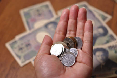 a hand with a lot of Japanese moneyの写真素材