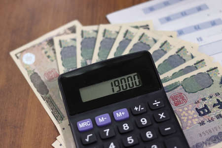 Calculator with 19,000 yen cash and receiptの写真素材