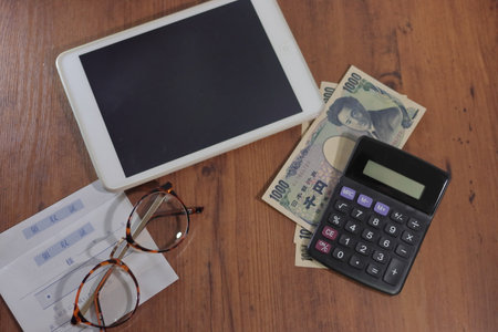 Tablet devices and glasses with calculator and cash and receiptsの写真素材