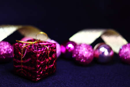 Pink colorful decoration and golden ribbon background texture (black background)
