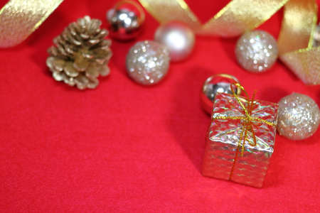 Gift box and golden decoration (red background)の写真素材