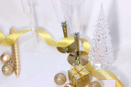Golden glitter decoration background texture with champagne glass and Christmas tree (white background)の写真素材