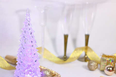 Golden glitter decoration background texture with champagne glass and Christmas tree (white background)の写真素材