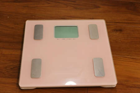 Pink Weight scales on wooden