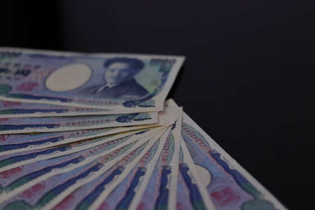 Japanese money placed side by side on a tableの写真素材