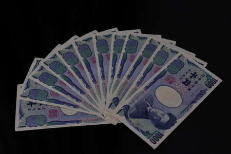 Japanese money placed side by side on a tableの写真素材