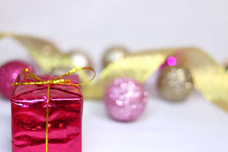 Pink and gold colorful and glittery decoration and gold ribbon and gift box background texture (white background)の写真素材