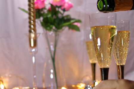 Image of a party pouring champagne into a glassの写真素材