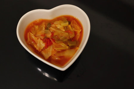 Healthy vegetable soup in a bowl of white heartsの写真素材