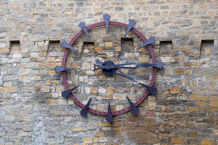 Old clock on the old wall. Vintage