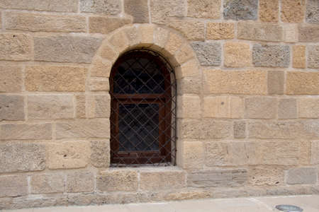 Lattice in a vintage style window in stone wallの写真素材