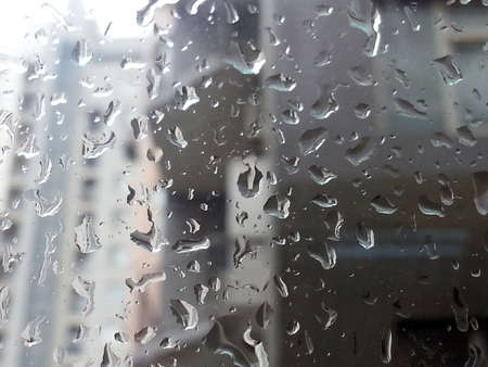 Rain drops on glass with a background.