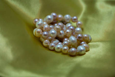 Colorful pearls necklace on a silk fabric