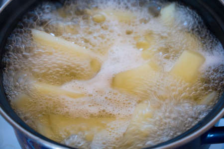 Cooking Potatoes In Boiling Water. Potatoes are being cooked in boiling water in a cooking pot.の写真素材