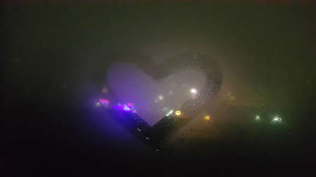 Abstract background - heart painted on a misted windowの写真素材