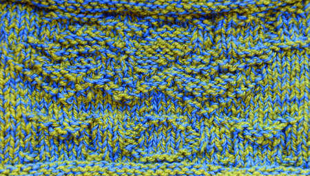 Fragment of a blue and olive cloth of manual knittingの写真素材