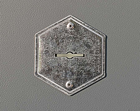 steel keyhole on the gray metal door