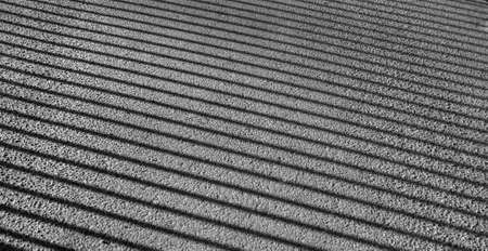 Natural geometrical laconic minimalist pattern. A shadow of rods of a fencing on asphalt....