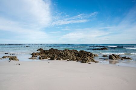 White sand and blue waves in South Africaの写真素材