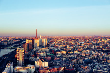 Eiffel tower between buildings in the last rays of the sun. Aerial view of Paris, Franceの写真素材