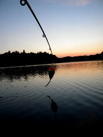 a float hanging down from a boat at sunsetの写真素材
