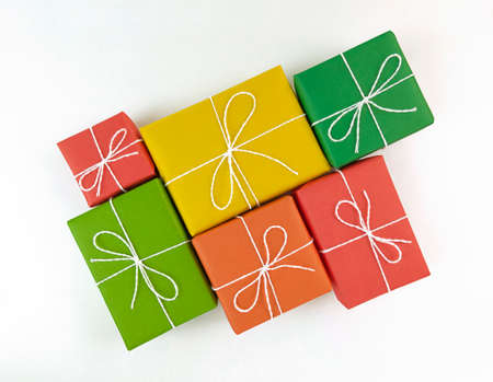 Red, yellow, green and orange gift boxes on white background.
