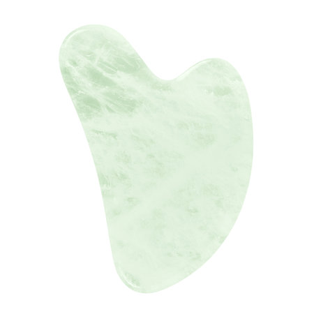Green Gua Sha scraper, massage tool isolated on white background.の写真素材