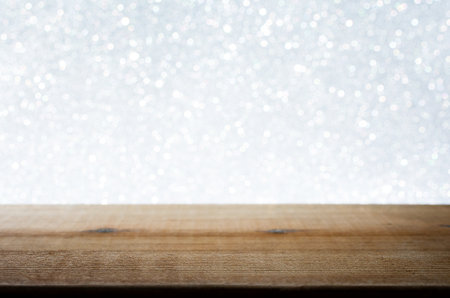 Wooden Table with White Bokeh Background. Festive Light Backdrop. Stock photo.の写真素材