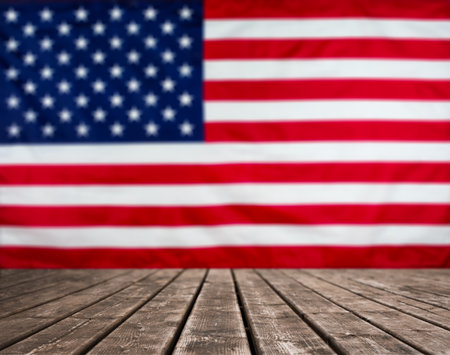 Wooden Table. Blurred American flag background with copy space. Stock photo.の写真素材