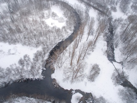 Winter background with a snow-covered forest with the captured drone. aerial photographyの写真素材