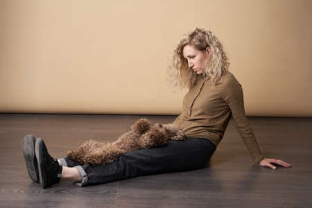 girl and chocolate poodle. the dog is belly up. Attitude, love, commitment