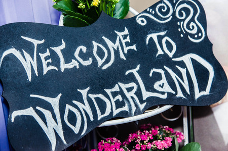the chalk lettering "welcome to wonderland" on the chalkboardの写真素材
