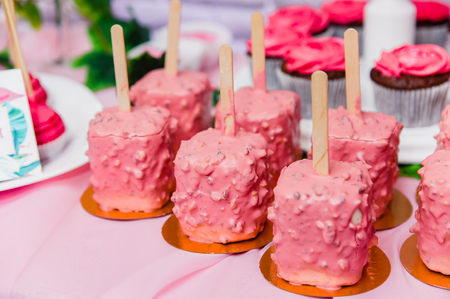 pink square tasty candies on sticksの写真素材