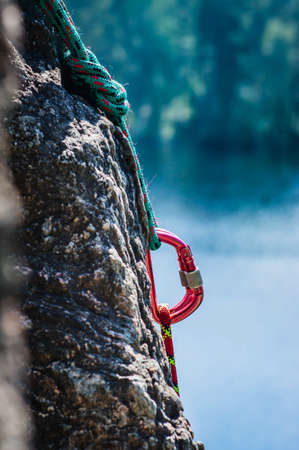 carabiner between two ropes on a rockの写真素材