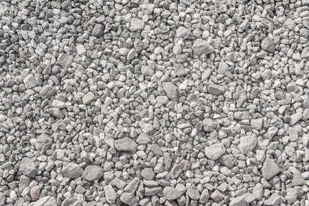 A pattern of gray and white gravel. The road surface is made of crushed stone and limestoneの写真素材