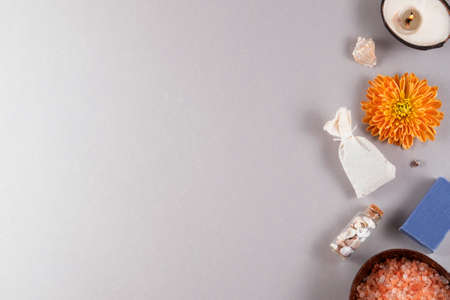 Scented sea salt and lavender soap, grass pouch for massage, beutiful flower, little seashells and coconut candle for relaxed mood.の写真素材