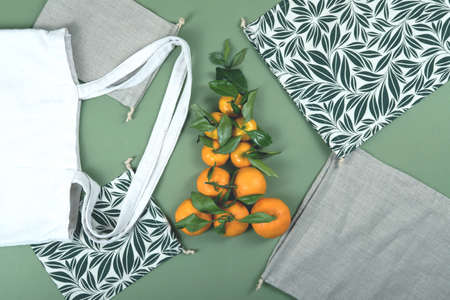Beuatiful composition of mandarins and cotton, zero waste and reusable bags and baggies.の写真素材