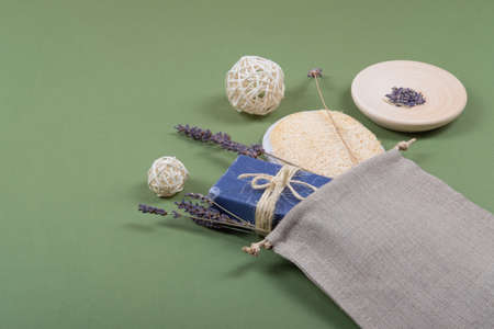Beautiful, natural and zero waste lavender soap and body scrubber composition with a reusable and linen baggie.の写真素材