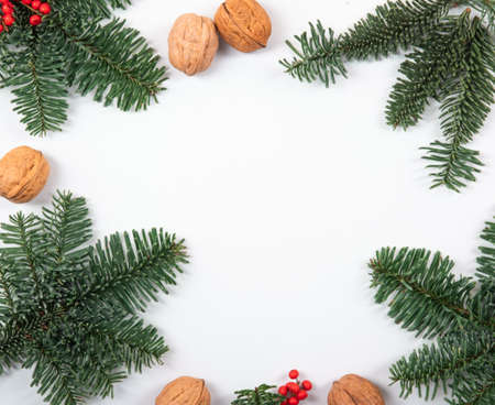 Beautiful, natural, reusable and zero waste frame composition of christmas objects such as walnuts, fresh and green pine branches.の写真素材