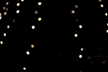 Beautiful bokeh gold lights of the festive New Year tree in the city.