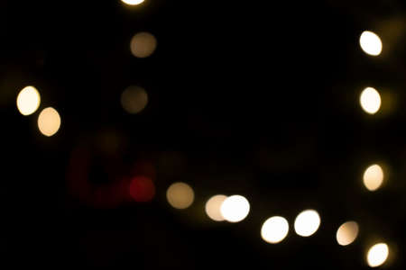 Beautiful bokeh gold lights of the festive New Year tree in the city.
