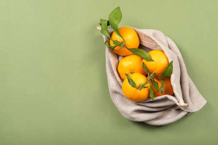 Fresh, fruity mandarins in linen and reusable bag.