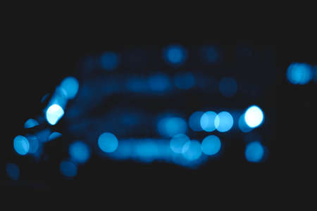 Beautiful and different bokeh lights of the night city in the trendy classic blue color of the year.の写真素材