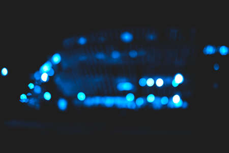 Beautiful and different bokeh lights of the night city in classic blue color.