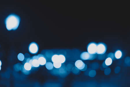 Beautiful and different bokeh lights of the night city in classic blue color.