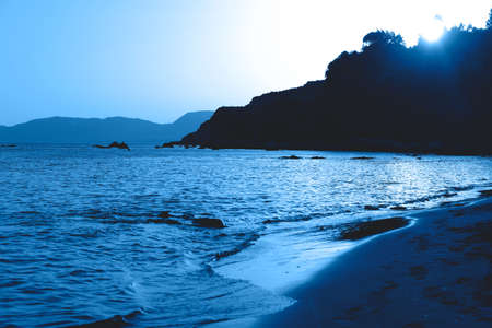 Beautiful seascape with the sunset in the trendy classic blue color of the year.の写真素材